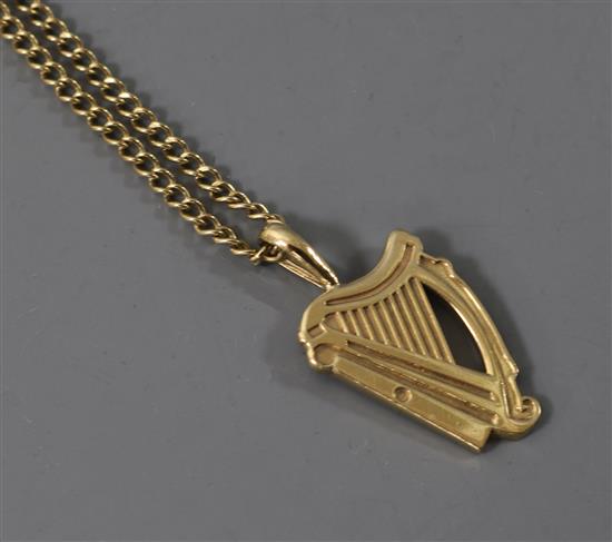 A 9ct gold harp pendant on a 9ct gold chain.